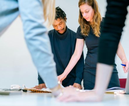 Business professionals engaged in a team meeting in a modern office setting.