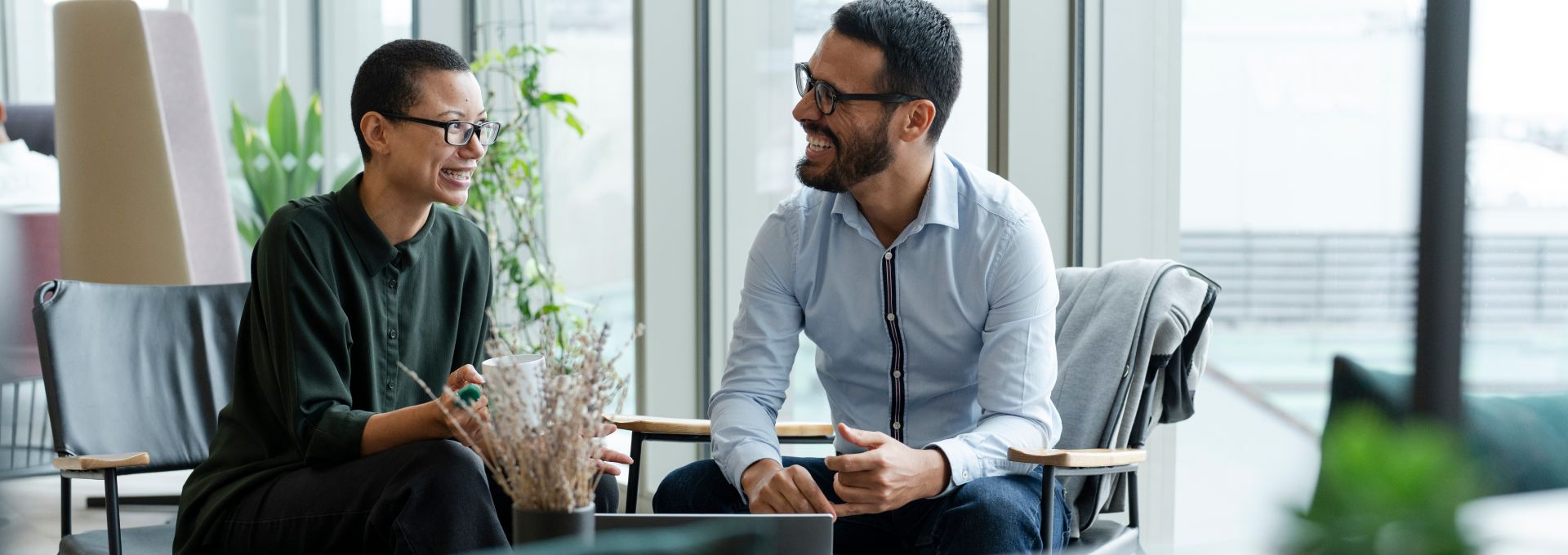 Confident woman working with calculator in bright office setting, surrounded by office tools.